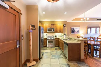 a kitchen with a sink and a stove top oven at Iron Horse Lodge North 310 by East West Hospitality in Truckee