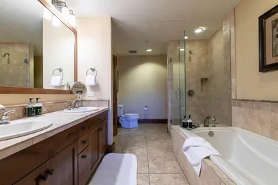 a bathroom with two sinks and a tub and a shower at Iron Horse Lodge South 305 by East West Hospitality in Truckee