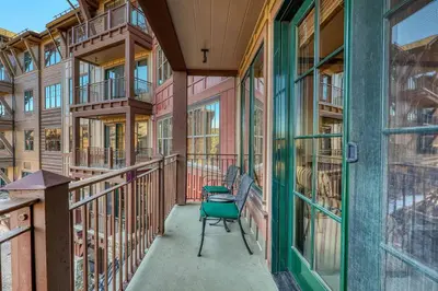 a balcony of a building with a bench and windows at Iron Horse Lodge South 305 by East West Hospitality in Truckee