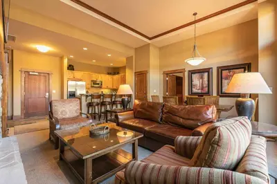 a living room with a couch and a table at Iron Horse Lodge North 107 by East West Hospitality in Truckee