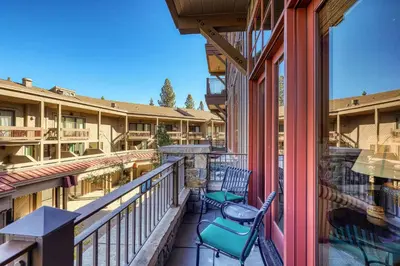 a balcony of a resort with chairs and tables at Iron Horse Lodge North 107 by East West Hospitality in Truckee