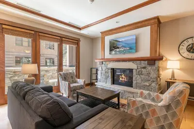 a living room with a couch and a fireplace at Iron Horse Lodge North 206 by East West Hospitality in Truckee