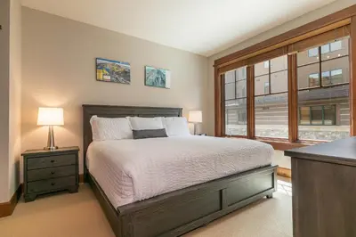 a bedroom with a bed and a window at Iron Horse Lodge North 206 by East West Hospitality in Truckee
