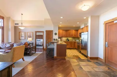 a kitchen and living room with a couch and a table at Iron Horse Lodge North 305 by East West Hospitality in Truckee