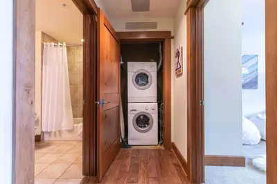 a laundry room with a washer and dryer in it at Iron Horse Lodge South 404 by East West Hospitality in Truckee