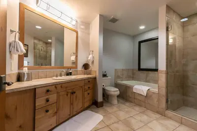 a bathroom with a sink and a shower and a toilet at Iron Horse Lodge South 209 by East West Hospitality in Truckee