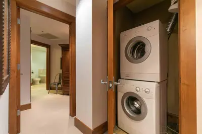 a laundry room with a washer and dryer at Iron Horse Lodge South 209 by East West Hospitality in Truckee