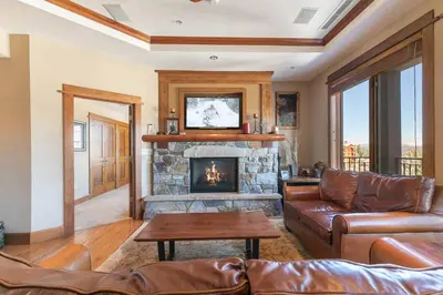 a living room with a couch and a fireplace at Iron Horse Lodge South 401 by East West Hospitality in Truckee