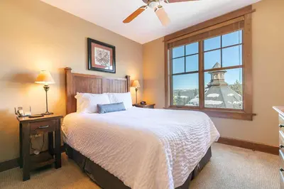 a bedroom with a bed and a window with the eiffel tower at Iron Horse Lodge South 401 by East West Hospitality in Truckee
