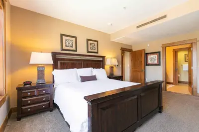a large bedroom with a large bed and a dresser at Iron Horse Lodge North 201 by East West Hospitality in Truckee