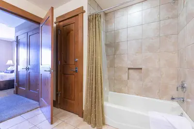 a bathroom with a bath tub and a shower at Iron Horse Lodge North 201 by East West Hospitality in Truckee