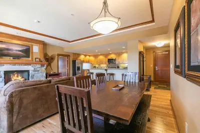 a dining room and living room with a table and a couch at Iron Horse Lodge North 201 by East West Hospitality in Truckee