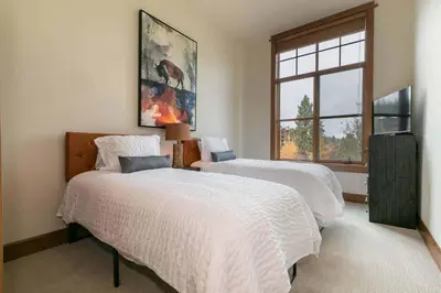 a bedroom with two beds and a window at Iron Horse Lodge North 103 by East West Hospitality in Truckee