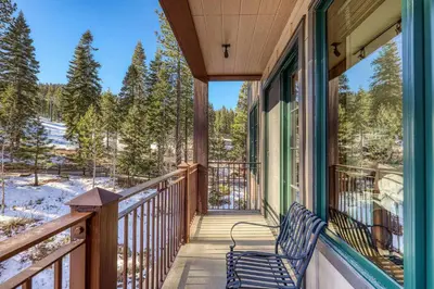 a porch of a house with a bench on it at Iron Horse Lodge South 308 by East West Hospitality in Truckee