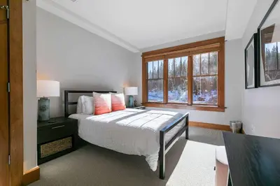 a bedroom with a large bed and a window at Iron Horse Lodge South 308 by East West Hospitality in Truckee