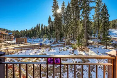 a winter view from the balcony of a house at Iron Horse Lodge South 308 by East West Hospitality in Truckee