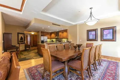 a dining room with a wooden table and chairs at Iron Horse Lodge South 312 by East West Hospitality in Truckee