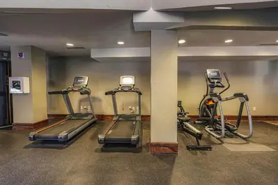 a gym with three tread machines in a room at One Village Place 502 by East West Hospitality in Truckee