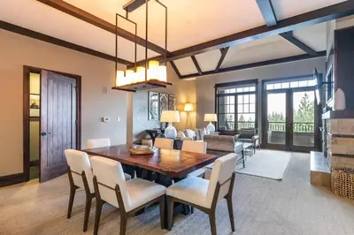 a dining room with a table and chairs at One Village Place 502 by East West Hospitality in Truckee