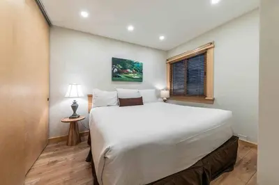 a bedroom with a large white bed and a window at Ski Trails 4115 by East West Hospitality in Truckee