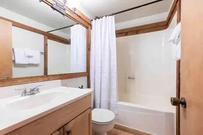 a bathroom with a sink and a toilet and a tub at Ski Trails 4099 by East West Hospitality in Truckee