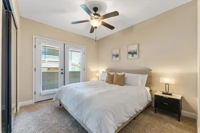 a bedroom with a bed and a ceiling fan at 2BR Getaway Pool Gym Basketball Court & Theater Access in Reno