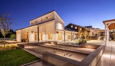 a building with a bunch of birds in front of it at 2BR Getaway Pool Gym Basketball Court & Theater Access in Reno