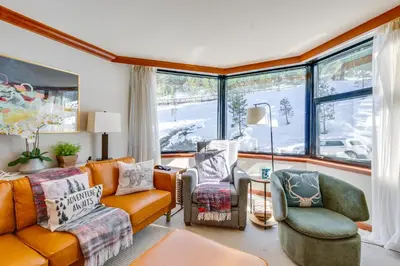 a living room with a couch and chairs and windows at Pool and Hot Tub Access! Condo in Olympic Valley in Olympic Valley