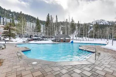 a large swimming pool with blue water in a resort at Ski-InandSki-Out and Resort Perks Olympic Valley Gem in Olympic Valley