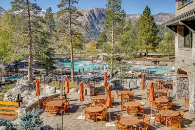 a patio with tables and chairs and a pool at Ski-InandSki-Out and Resort Perks Olympic Valley Gem in Olympic Valley