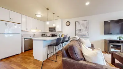 a living room with a couch and a kitchen at Lakeview Villas #24 condo in Mammoth Lakes