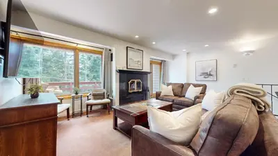 a living room with a couch and a fireplace at Lakeview Villas #24 condo in Mammoth Lakes