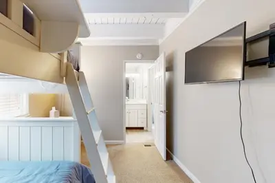 a bedroom with a bunk bed and a flat screen tv at The Great Escape in Incline Village