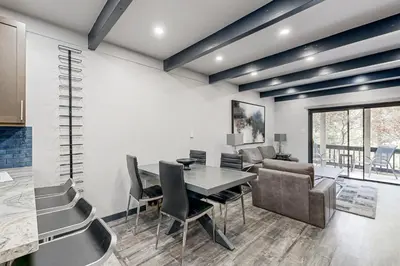 a dining room with a table and a couch at Modern Mountain Retreat in Incline Village