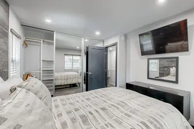 a bedroom with a bed and a tv on the wall at Modern Mountain Retreat in Incline Village