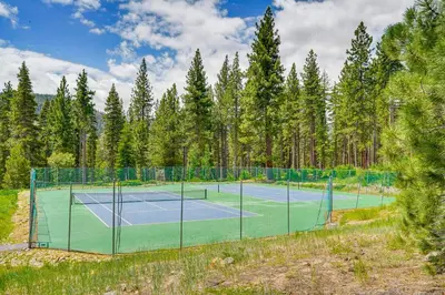 a tennis court with trees in the background at Close to Ski Slopes Tahoe Ski Chalet with Fireplace in Tahoe City