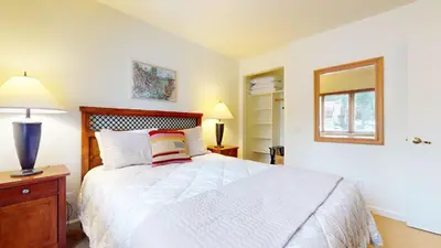 a bedroom with a large white bed and a window at Lakeview Villas #26 condo in Mammoth Lakes