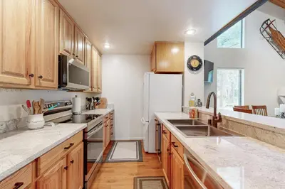 a kitchen with wooden cabinets and a white refrigerator at Kingswood Village #167 in Kings Beach