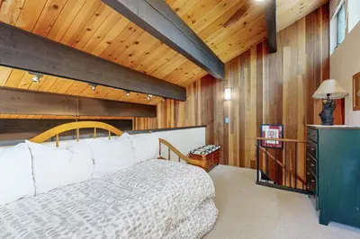 a bedroom with a large bed and a wooden ceiling at Kingswood Village #167 in Kings Beach