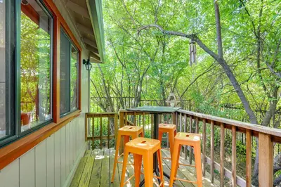a porch with a table and stools on it at Downtown Fair Oaks Home about 15 Mi to Sacramento! in Fair Oaks