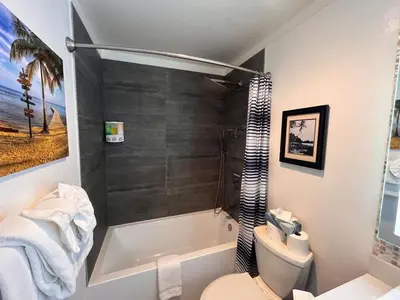 a bathroom with a tub and a toilet and a sink at Walk-to-Lifts Condo with Hot Tub, Dog Friendly in Mammoth Lakes