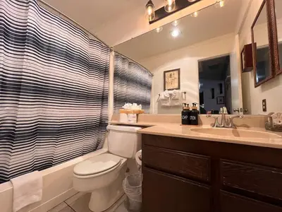 a bathroom with a toilet and a sink and a shower at Walk-to-Lifts Condo with Hot Tub, Dog Friendly in Mammoth Lakes