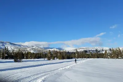 a person cross country skiing across a snow covered field at Cozy Corner Tamarack Condo 19 in Tamarack