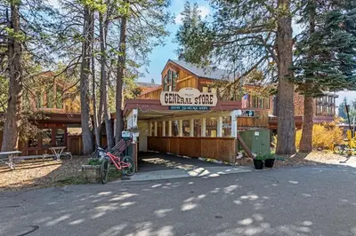 a large wooden building with a sign on it at Cozy Corner Tamarack Condo 19 in Tamarack