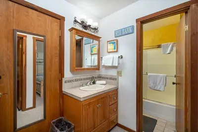 a bathroom with a sink and a shower at Cozy Corner Tamarack Condo 19 in Tamarack