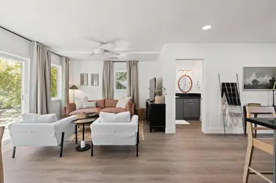 a living room with white chairs and a couch at The River House in Three Rivers