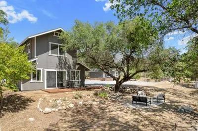 a house with a tree in front of it at The River House in Three Rivers