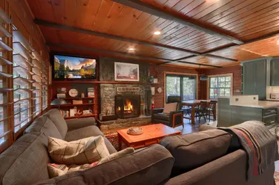 a living room with a couch and a fireplace at 45 The Overlook in Wawona