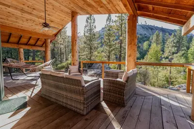 a porch with chairs and a view of the mountains at Peppermint Falls Ranch in Ponderosa