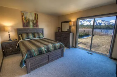 a bedroom with a bed and a large window at Epiphany home in South Lake Tahoe